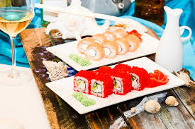 Plated sushi rolls with garnish on a table.